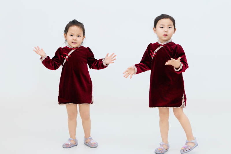 白色背景下顽皮可爱的双胞胎小女孩图片