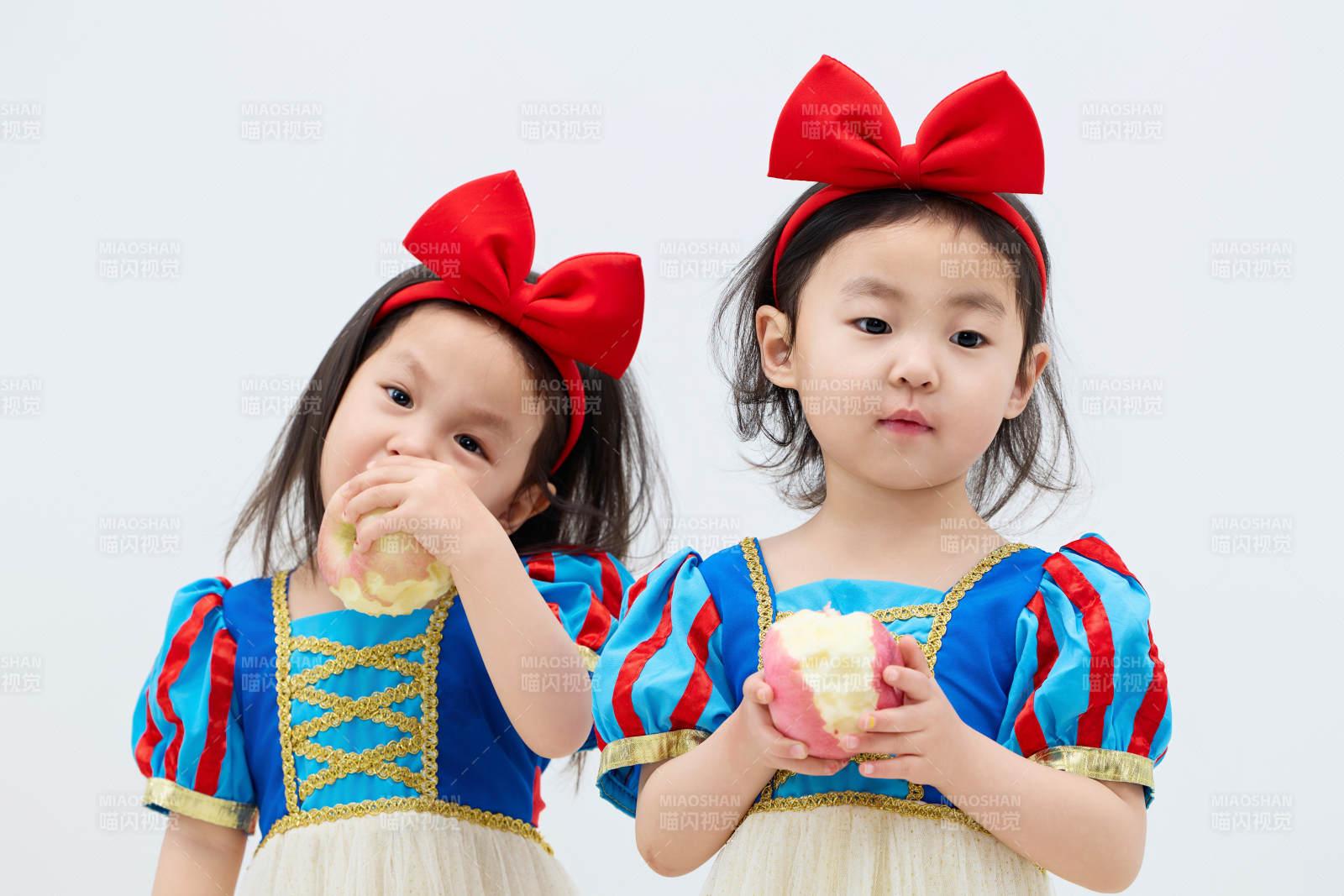 白色背景下顽皮可爱的双胞胎小女孩图片