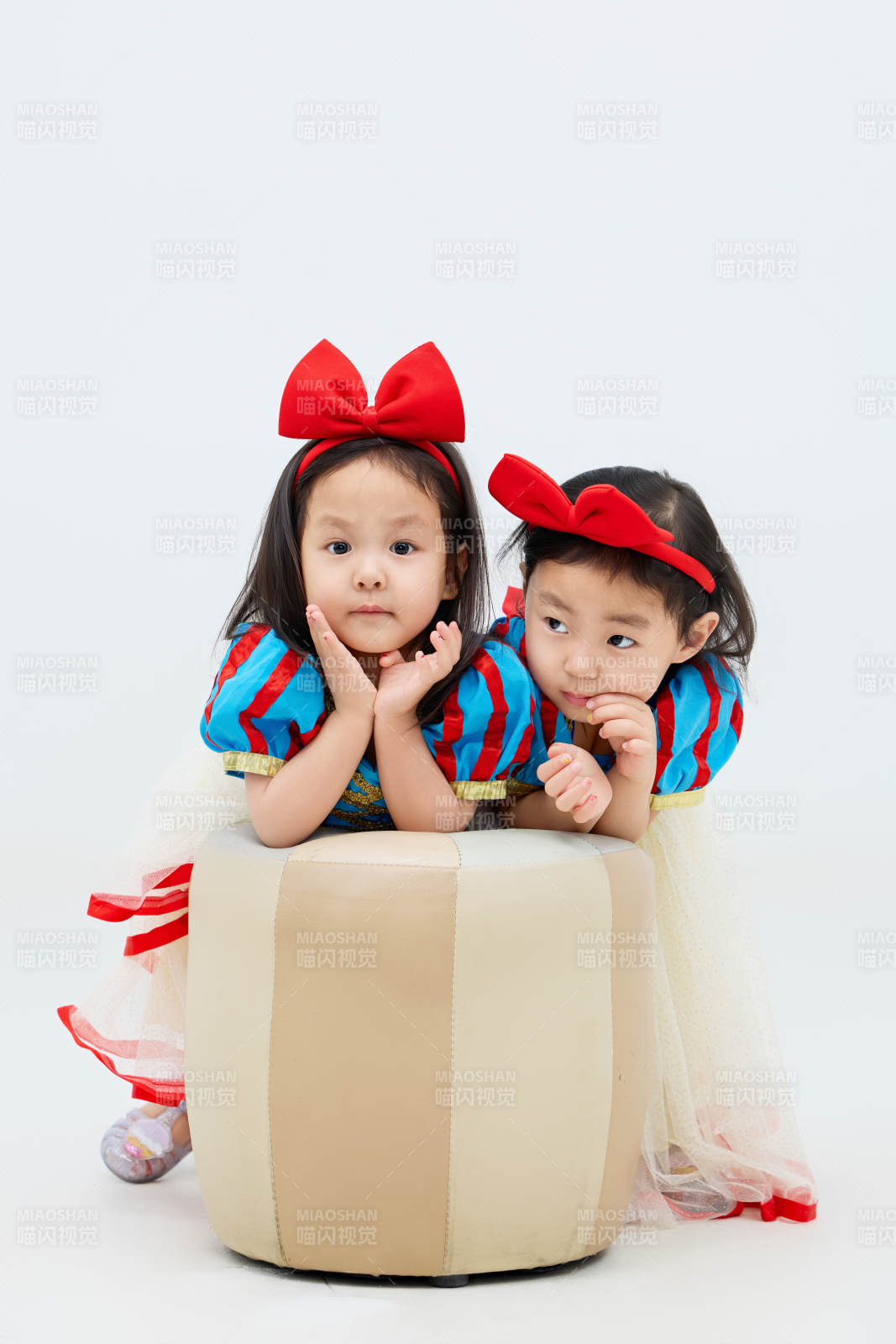 白色背景下顽皮可爱的双胞胎小女孩图片