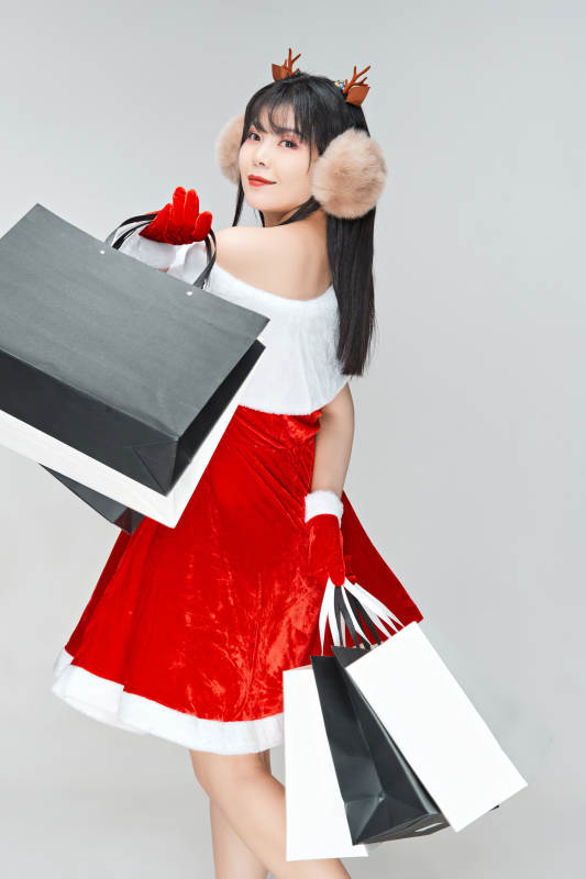 身穿圣诞服饰手提购物袋性感可爱的圣诞女郎图片