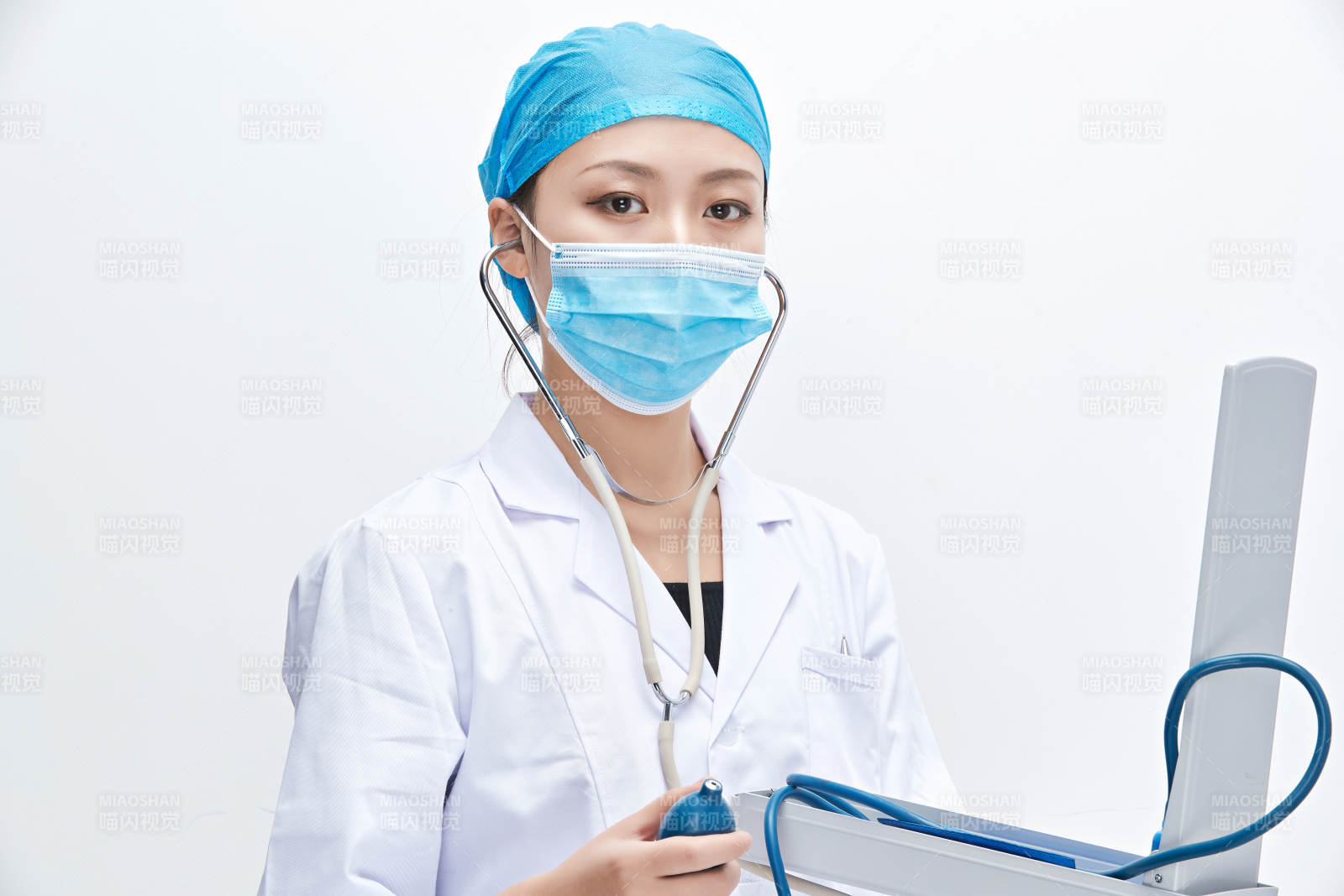 白色背景下手持血压计的门诊医生图片