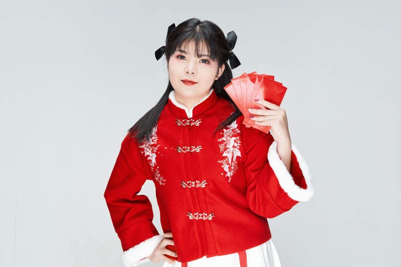 白色背景下身穿喜庆汉服手拿红包的可爱少女图片
