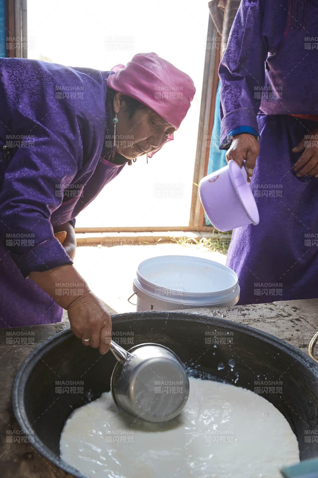 在蒙古包内用传统工艺熬煮制作奶豆腐过程图片