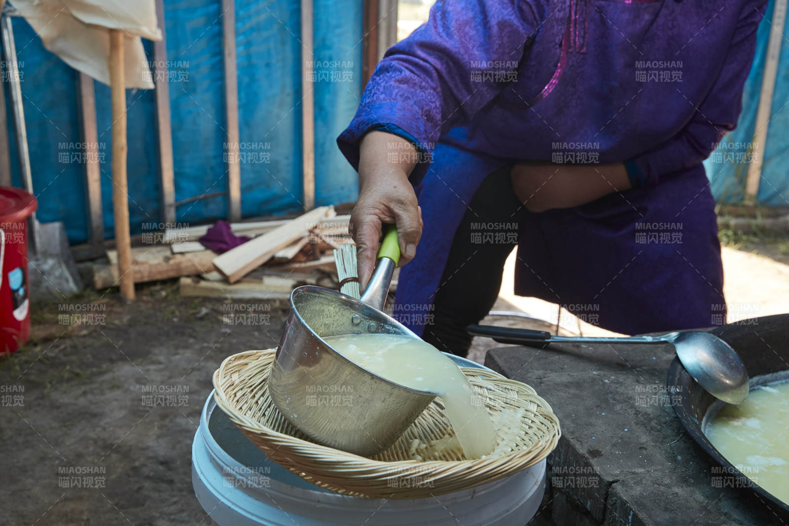 在蒙古包内用传统工艺熬煮制作奶豆腐过程图片