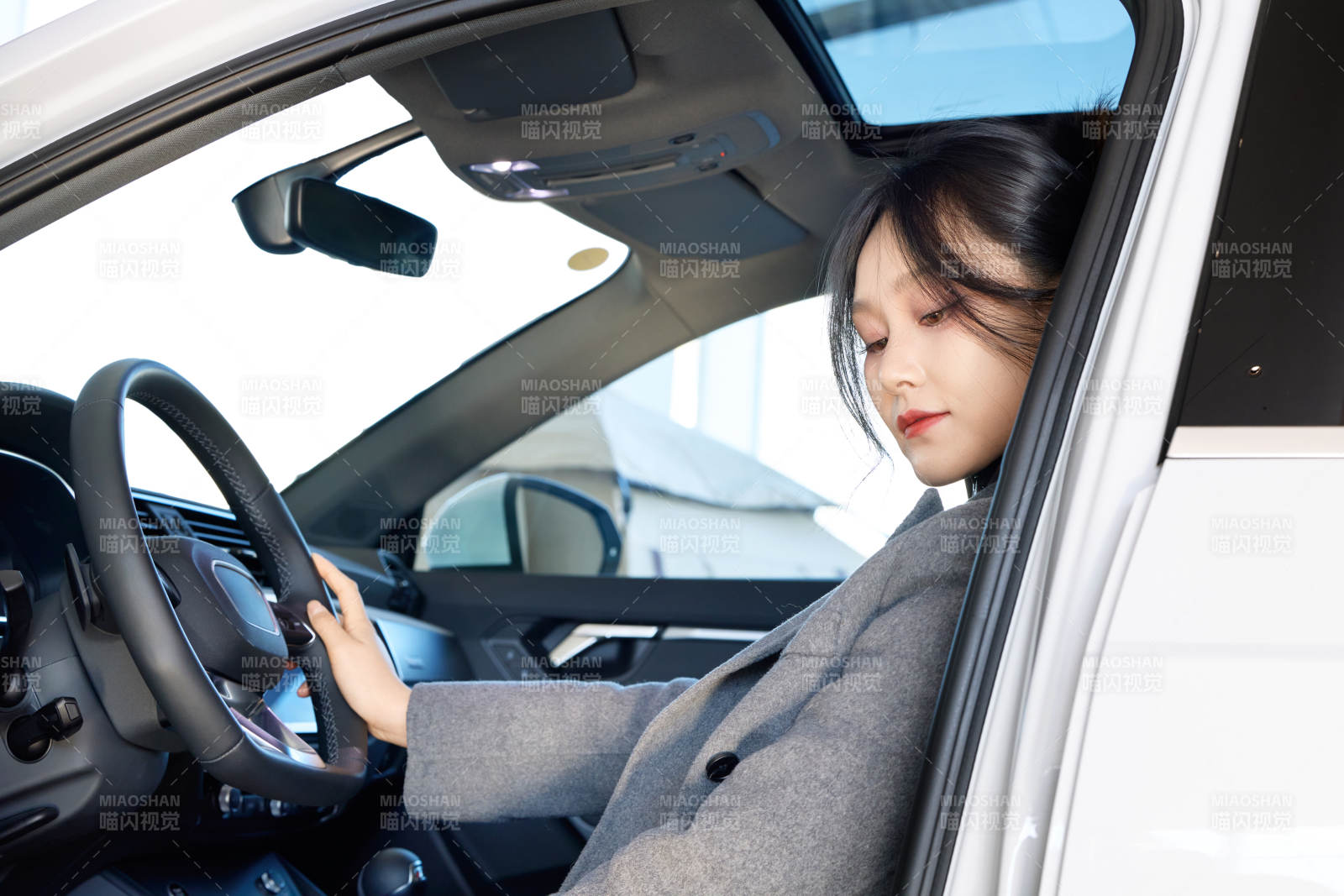 在汽车4S店试驾车辆的亚洲美女图片