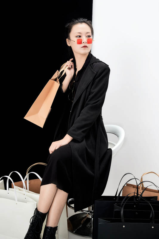 黑白色背景下的手提购物袋的时尚亚洲少女图片