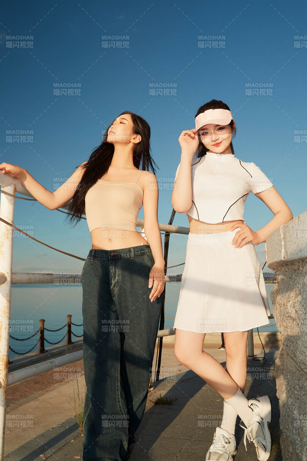 盛夏在景区湖边灯塔上拍照游玩的美女们图片