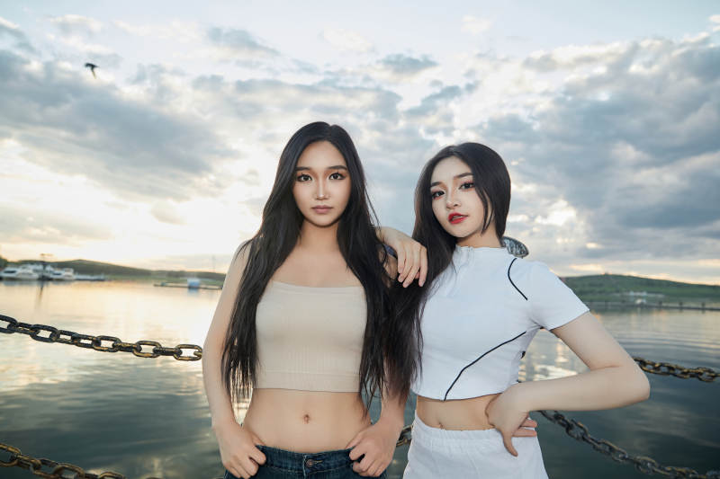 傍晚在湖边欣赏风景拍照的亚洲美女们图片