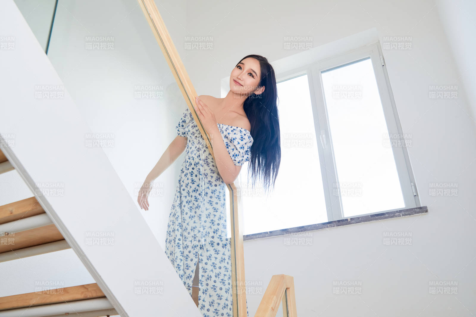 在别墅内的楼梯上拍照的亚洲美女图片