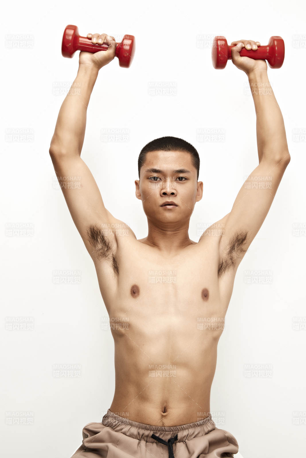 使用哑铃进行健身锻炼的亚洲男性图片