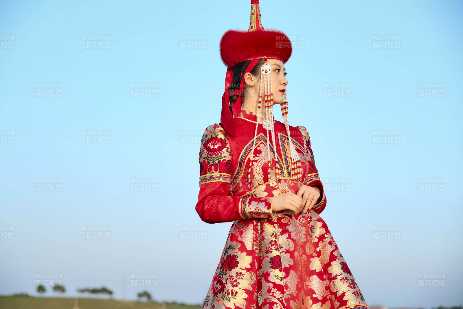 草原上穿着蒙古族传统服饰的亚洲年轻美少女图片