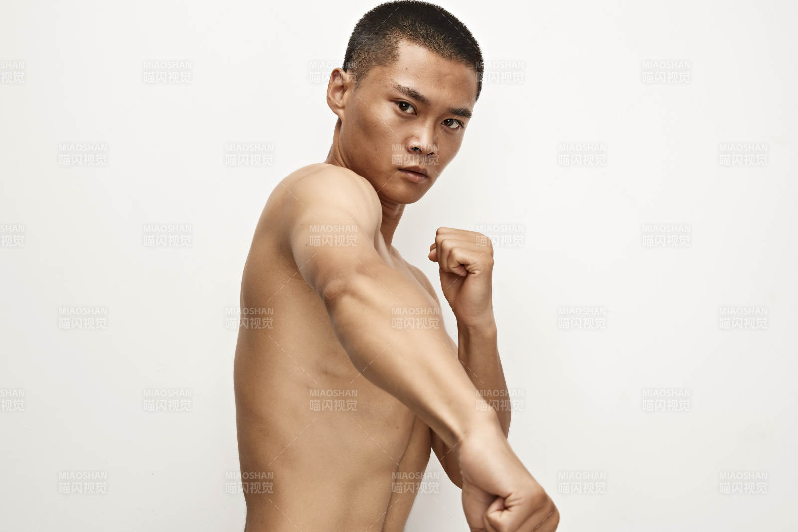 白色背景下演示自由搏击动作的亚洲功夫男性图片