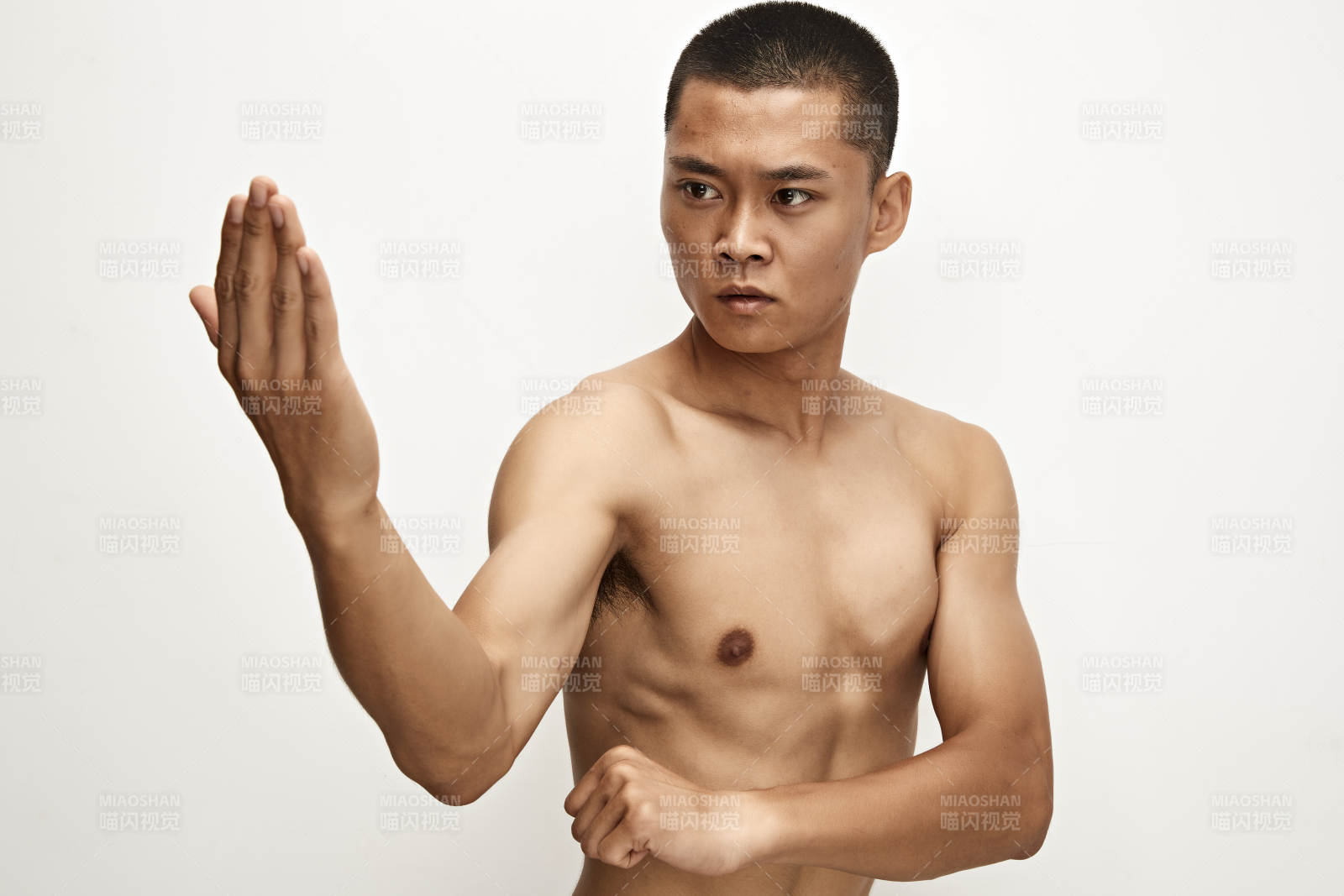 白色背景下演示自由搏击动作的亚洲功夫男性图片
