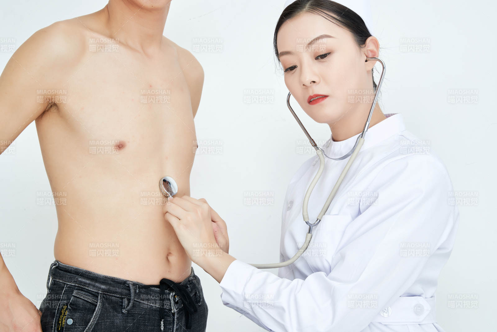 佩戴听诊器的女性医护人员为患者听诊检查图片