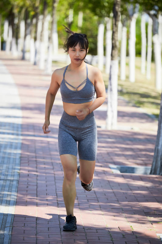 户外河畔公园进行跑步锻炼的亚洲女性图片