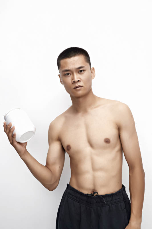 手持蛋白粉的身材匀称肌肉扎实的亚洲男性图片