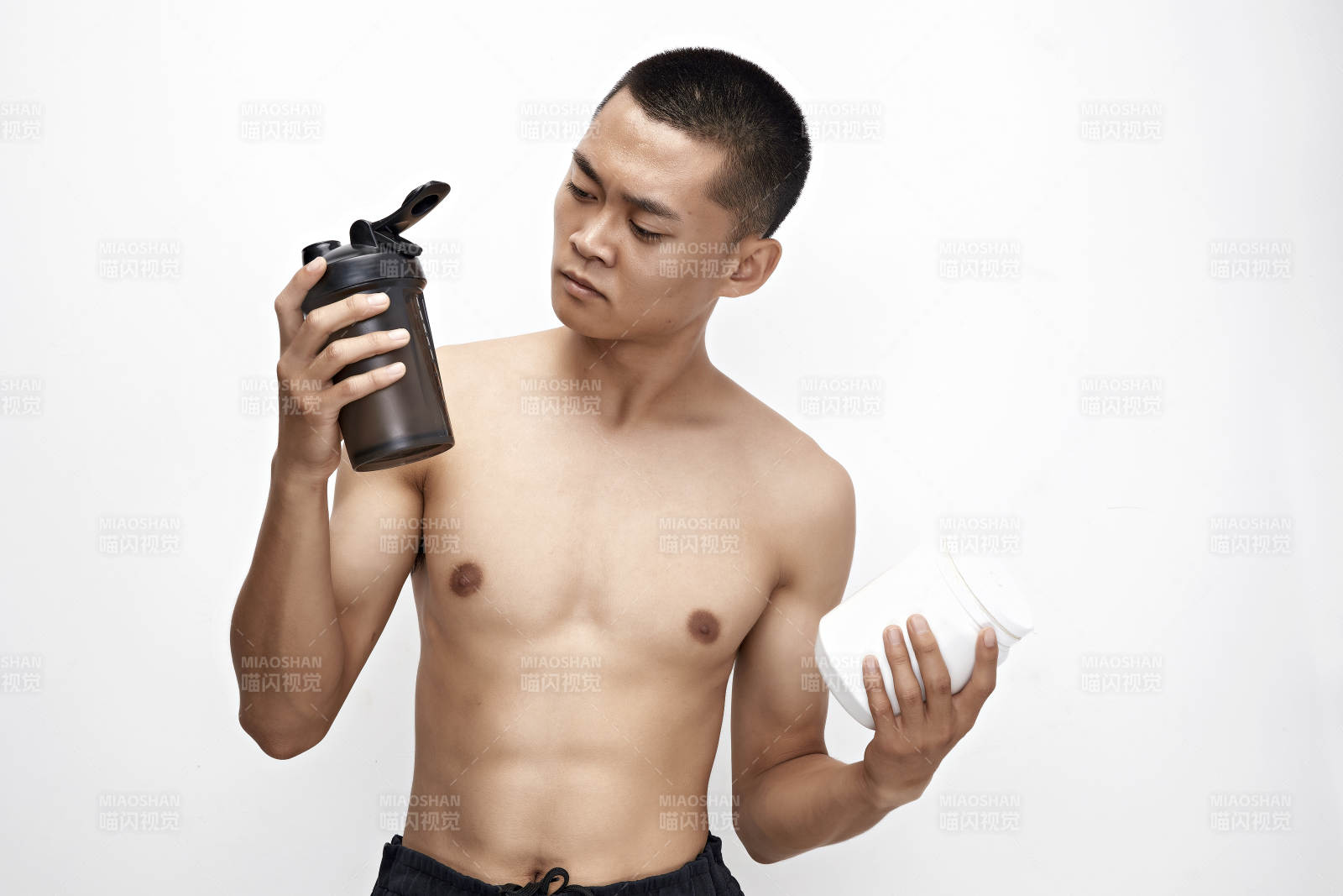 手持蛋白粉的身材匀称肌肉扎实的亚洲男性图片