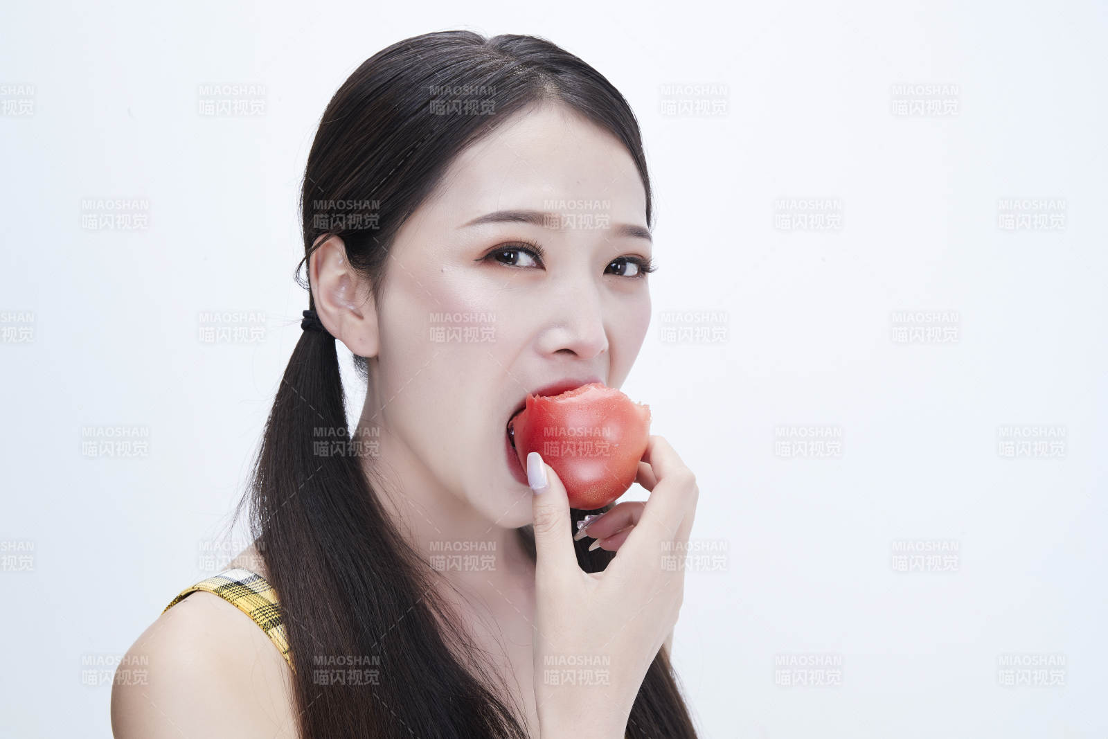 啃咬番茄身穿格子吊带裙的亚洲可爱少女人像图片