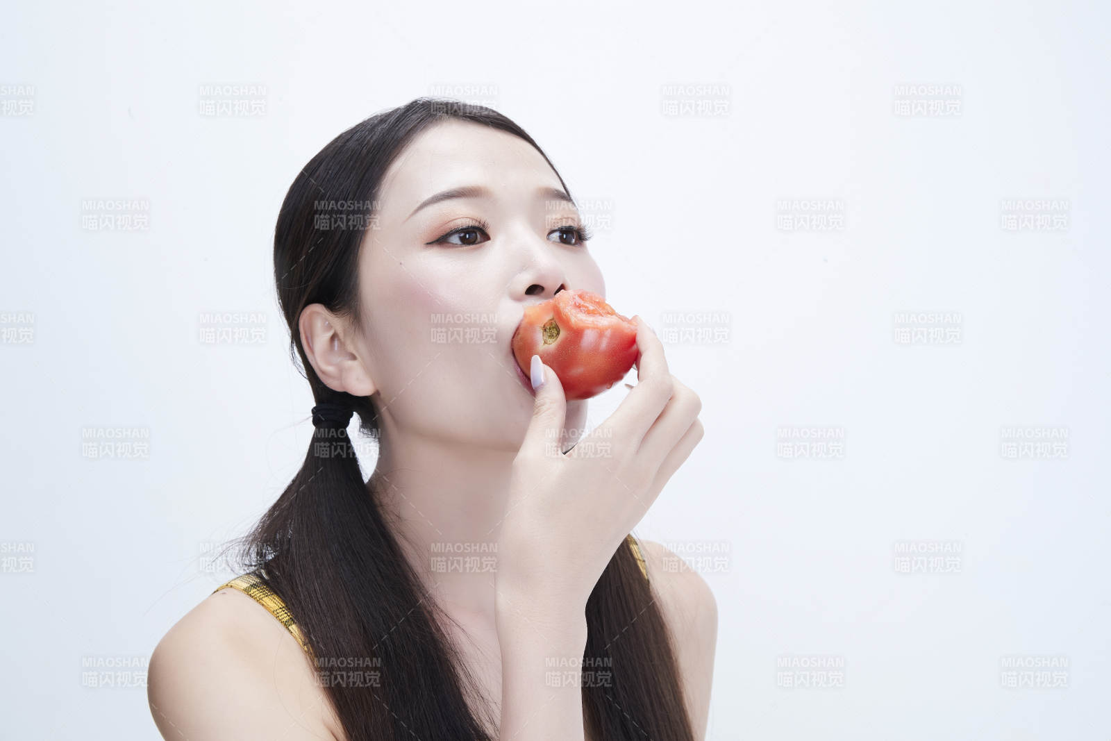 啃咬番茄身穿格子吊带裙的亚洲可爱少女人像图片