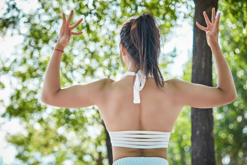 湖畔公园做瑜伽动作的亚洲年轻女性图片