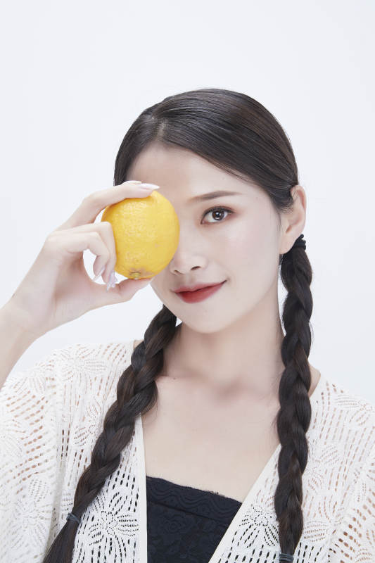 手拿柠檬身穿镂空连衣裙的亚洲可爱少女人像图片