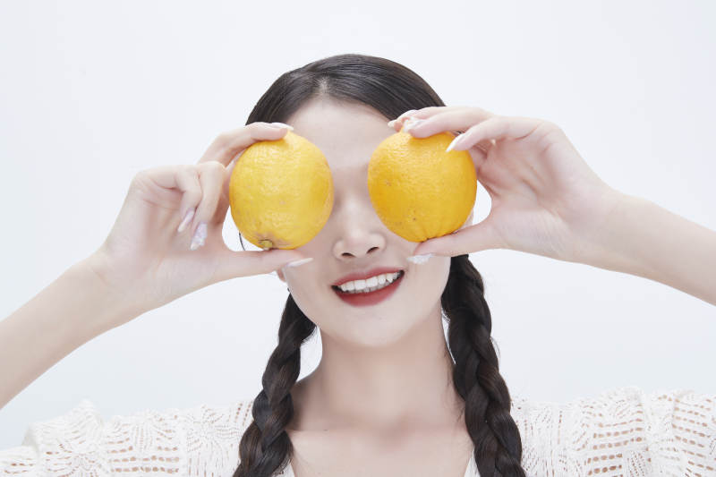 手拿柠檬身穿镂空连衣裙的亚洲可爱少女人像图片