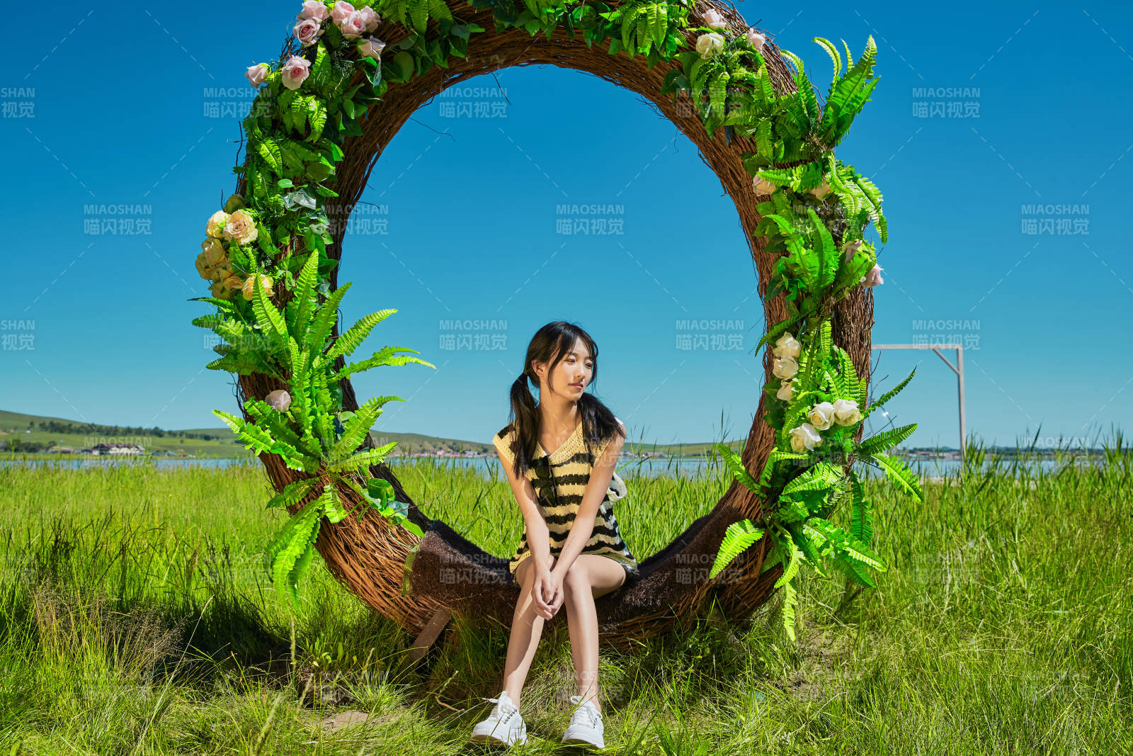 草原湖畔打卡点游玩拍照的亚洲少女图片