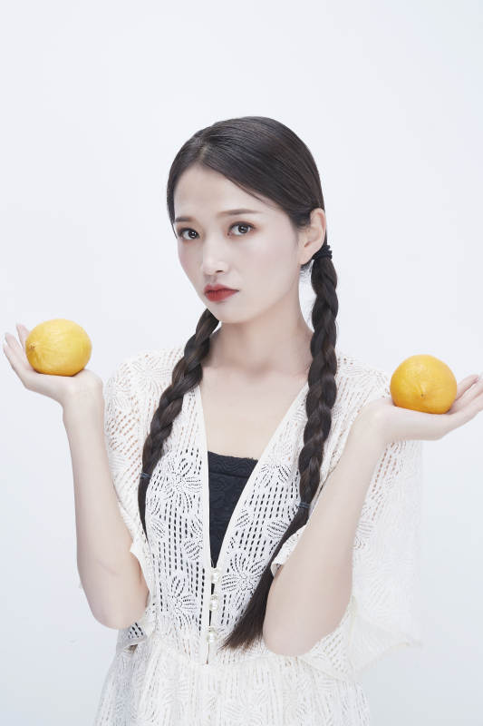 手拿柠檬身穿镂空连衣裙的亚洲可爱少女人像图片