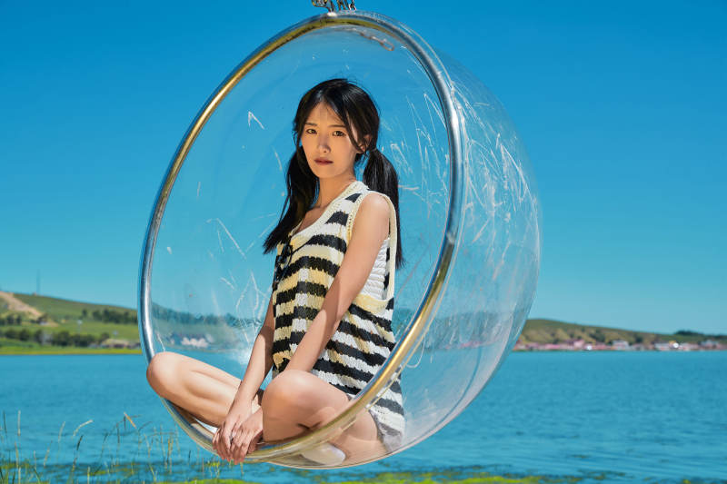 草原湖畔打卡点游玩拍照的亚洲少女图片