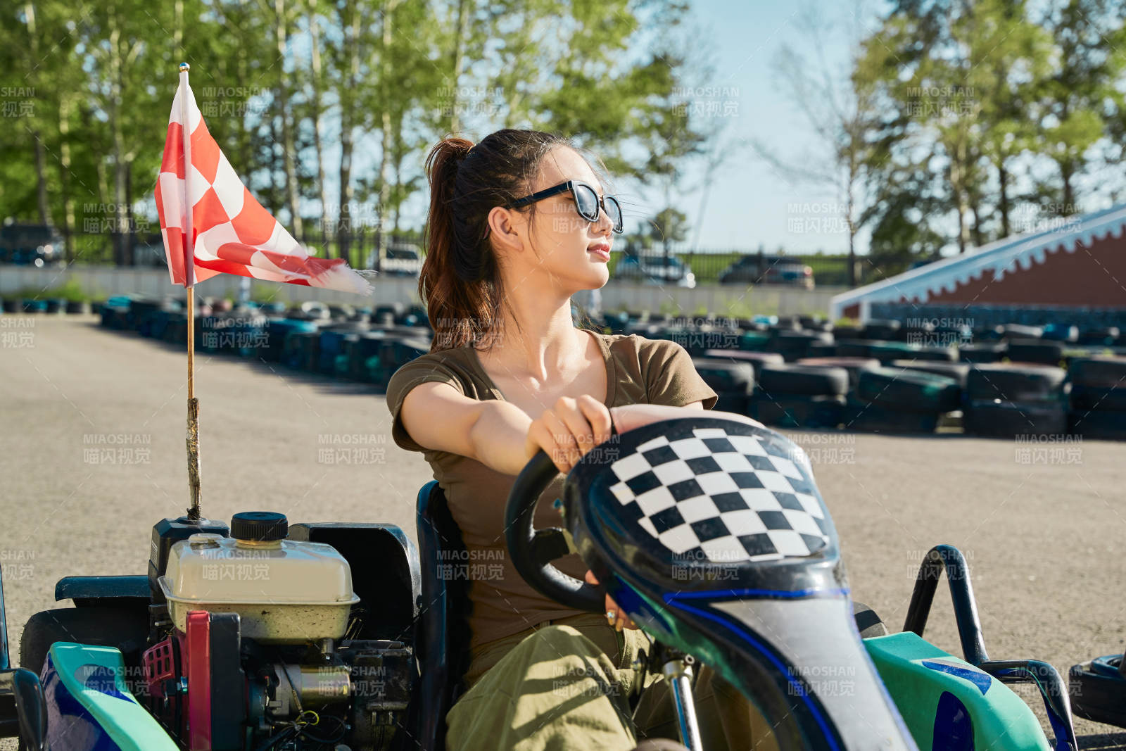 在游乐场卡丁赛道上驾驶卡丁车的美女图片