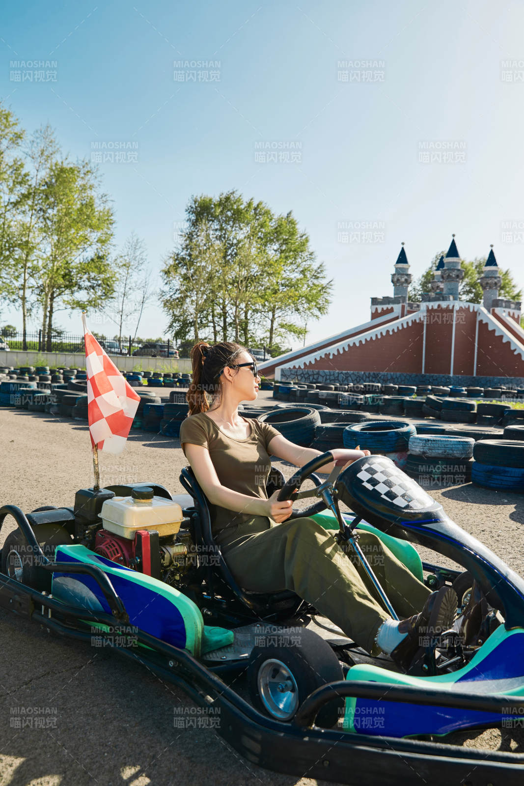 在游乐场卡丁赛道上驾驶卡丁车的美女图片