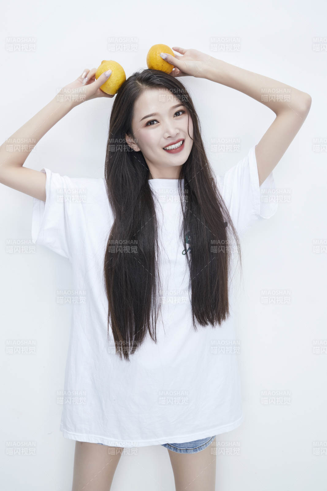 手拿柠檬身穿白色长T血的亚洲可爱少女人像图片