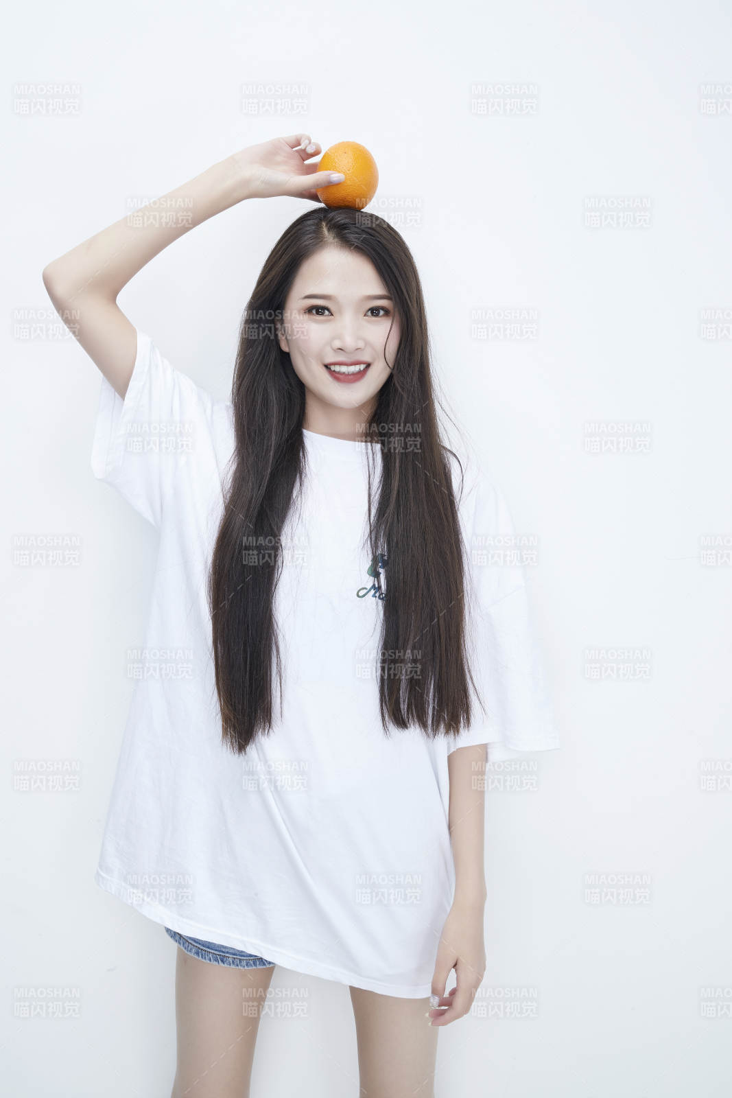 玩耍橙子穿白色长T血的亚洲可爱少女人像图片