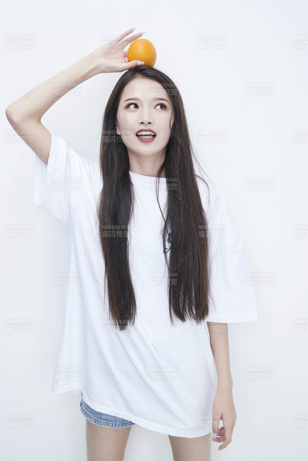 玩耍橙子穿白色长T血的亚洲可爱少女人像图片