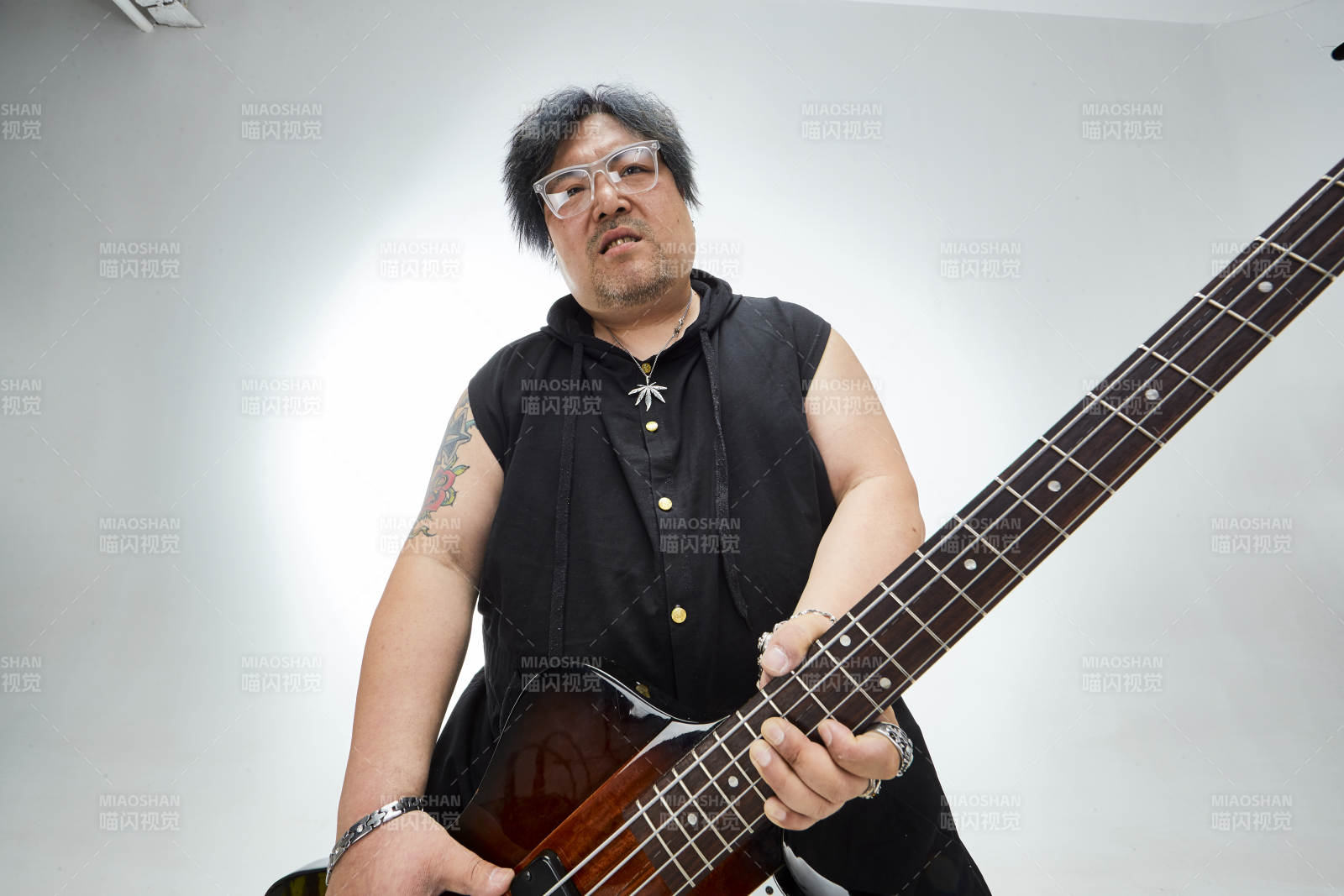 手持贝斯.低音吉他展示演奏的男性乐手人像图片