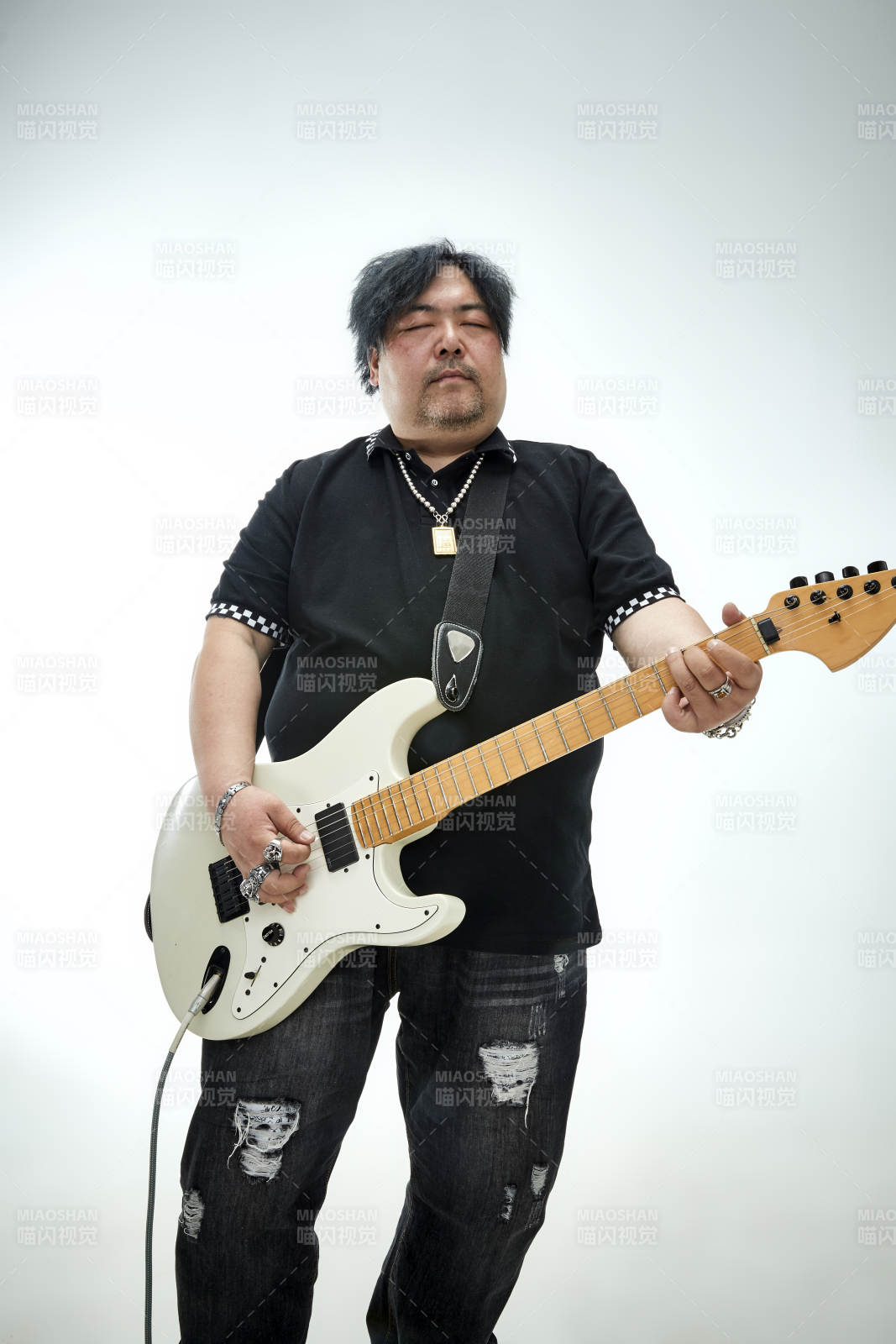 手持电吉他展示演奏的亚洲男性摇滚乐手人像图片