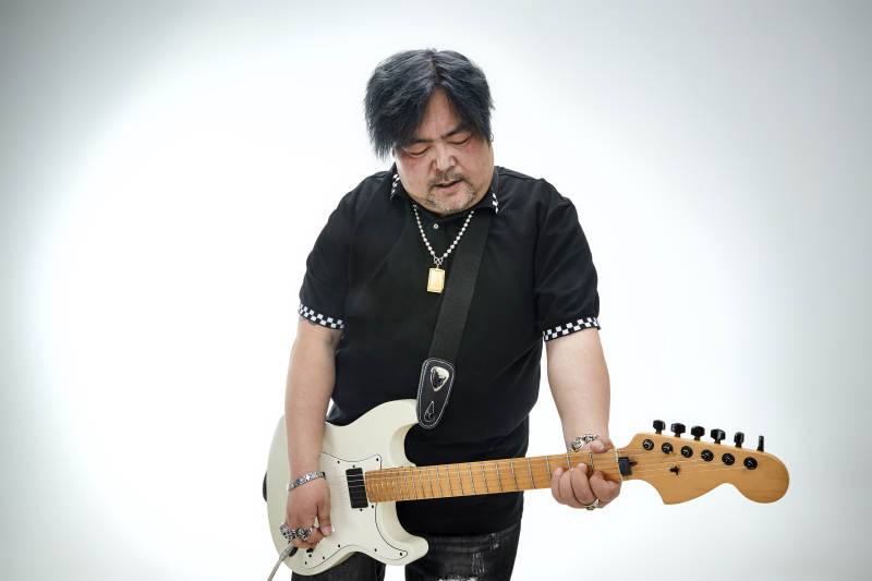 手持电吉他展示演奏的亚洲男性摇滚乐手人像图片