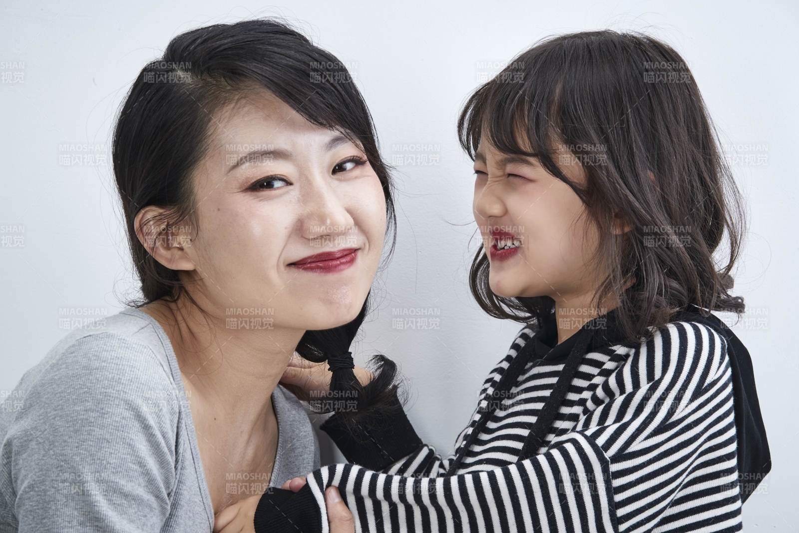 白色背景的美丽妈妈与可爱女儿亲子人像图片
