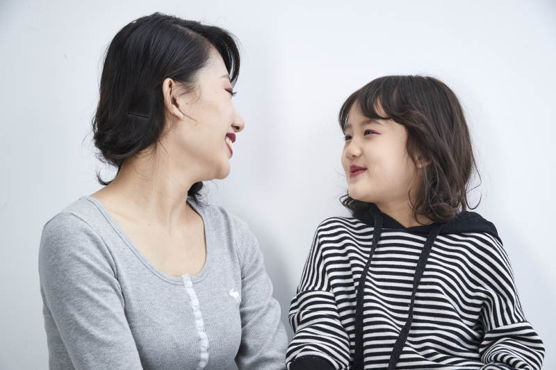 白色背景的美丽妈妈与可爱女儿亲子人像图片