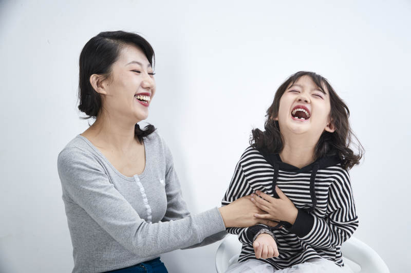 白色背景的美丽妈妈与可爱女儿亲子人像图片