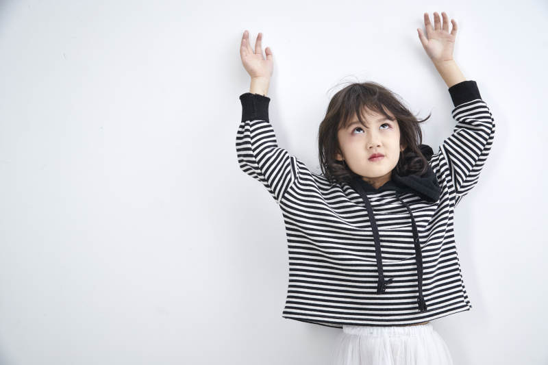 白色背景前身穿海魂衫的可爱的亚洲儿童人像图片