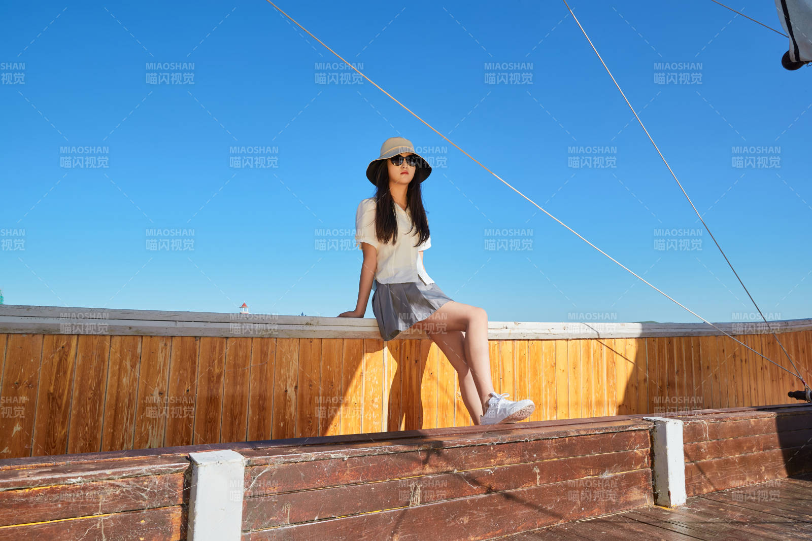 在湖畔木制帆船上的亚洲美女图片