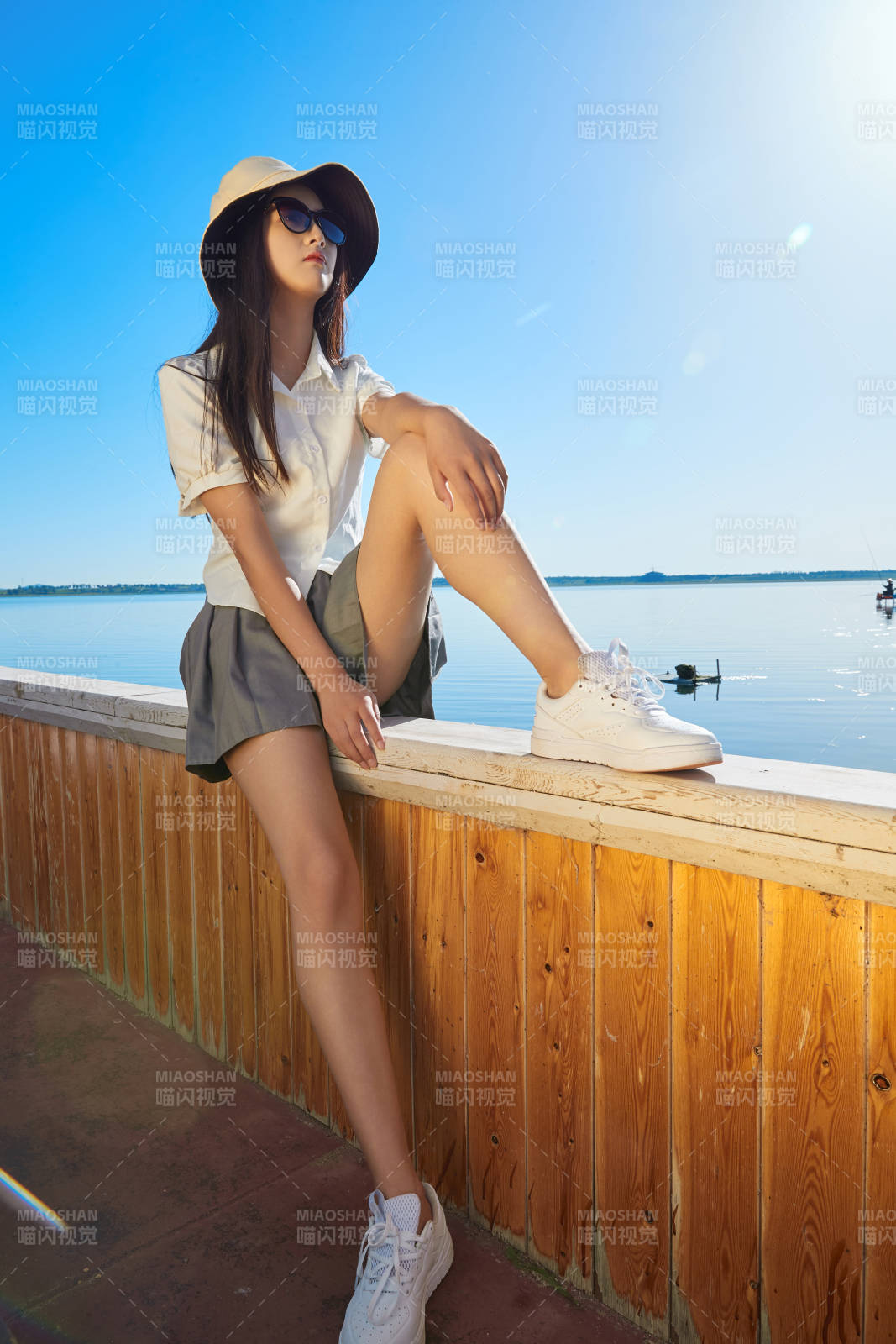 在湖畔木制帆船上的亚洲美女图片