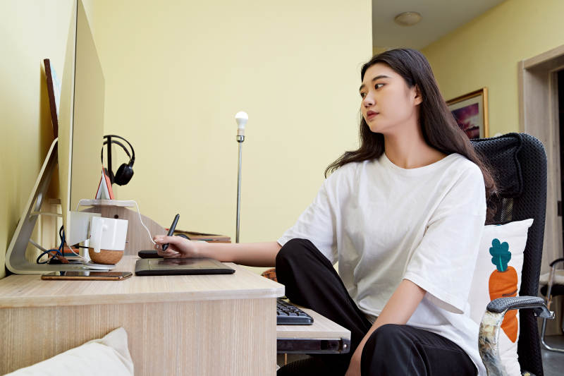 居家在电脑前创作插画的年轻美女图片