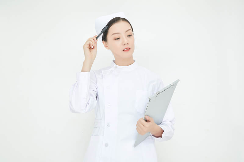 白背景里穿护士服手持病历夹的美女护士图片