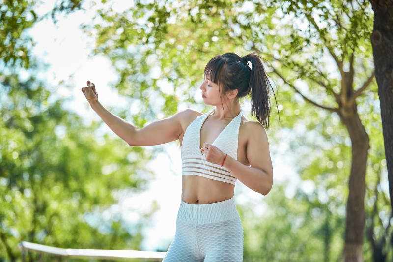 湖畔公园做瑜伽动作的亚洲年轻女性图片