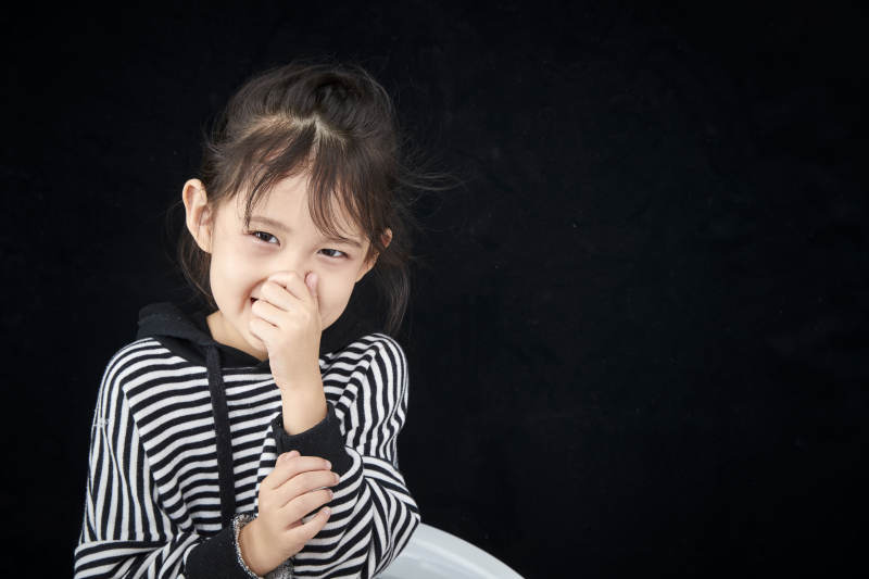 黑色背景的调皮可爱的亚洲小女孩儿童图片