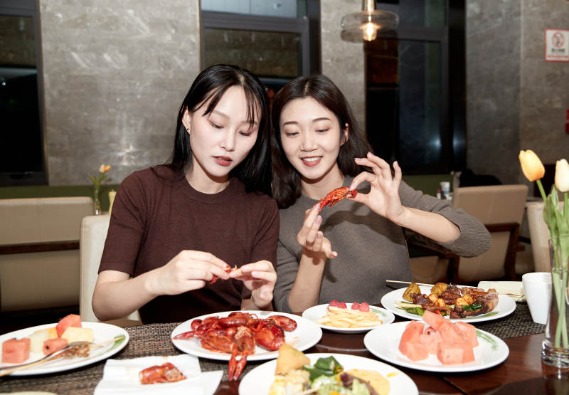 在酒店自助餐厅大吃特吃的亚洲可爱闺蜜少女图片