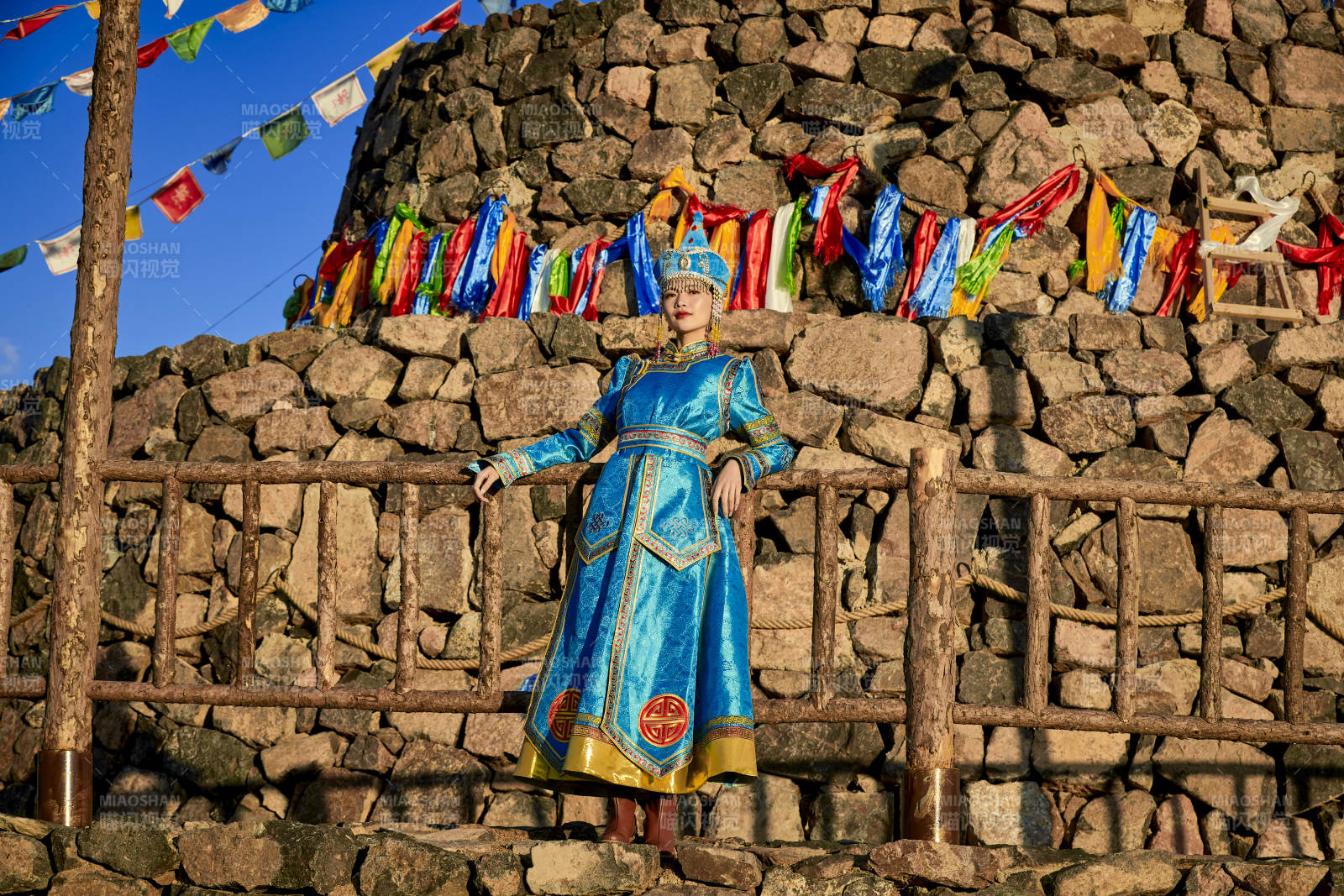 草原上敖包前身穿豪华蒙古族服饰的蒙族少女图片