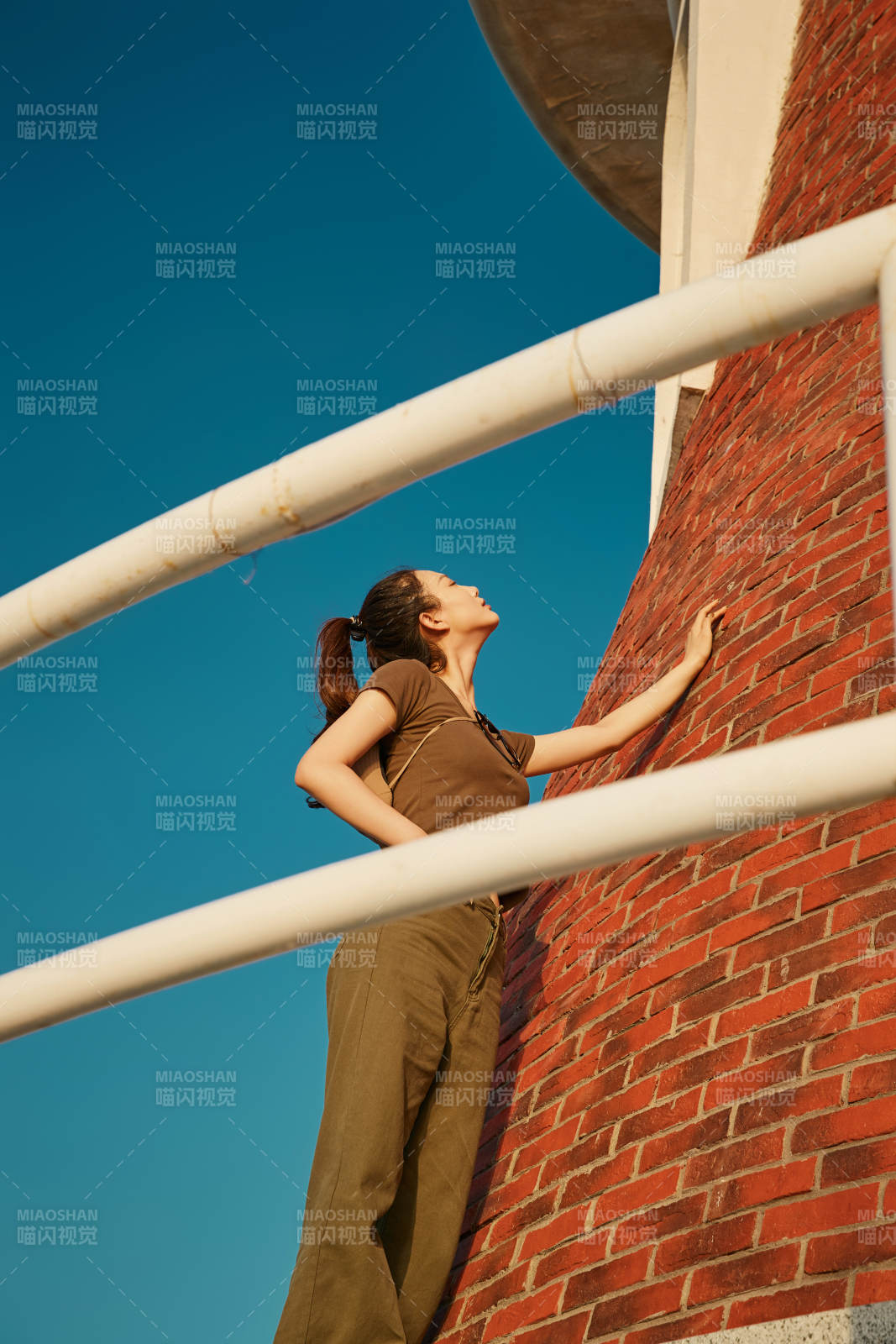 盛夏夕阳晚霞湖边码头灯塔上的少女图片